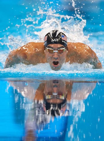 Photos Michael Phelps [États-Unis] en action lors des demi-finales du 100 mètres papillon hommes, photographie de Donald Miralle, 2016.
